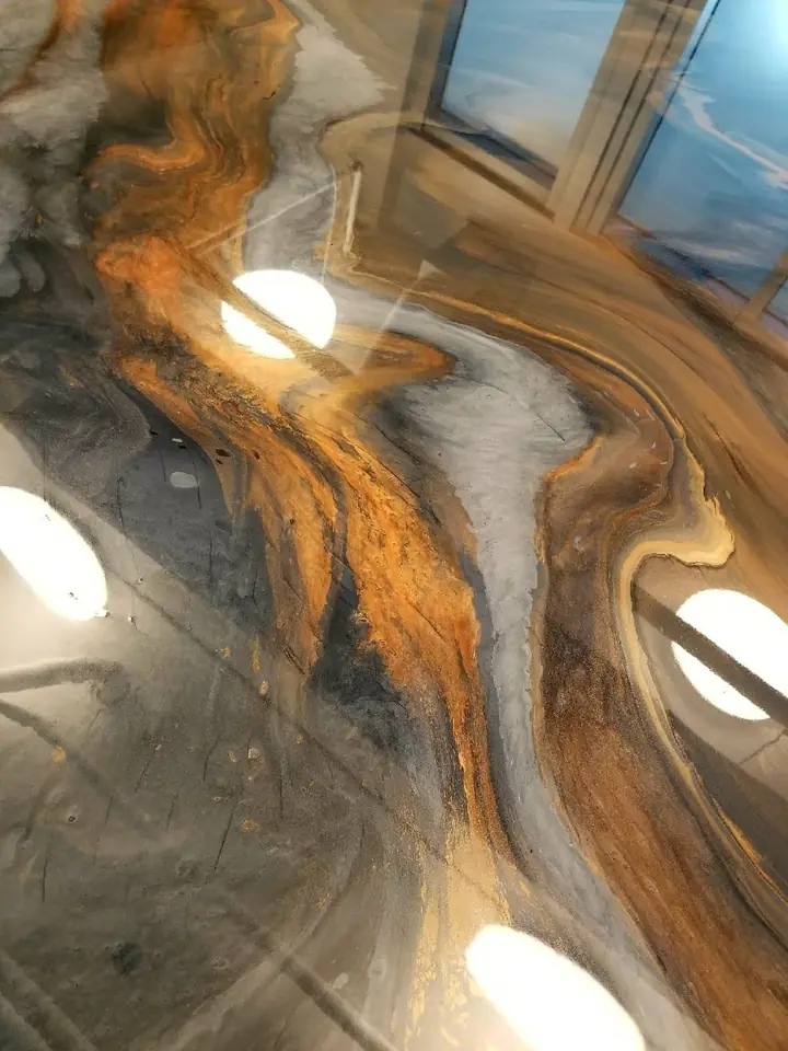 Copper, grey and white metallic epoxy swirling across a glossy floor