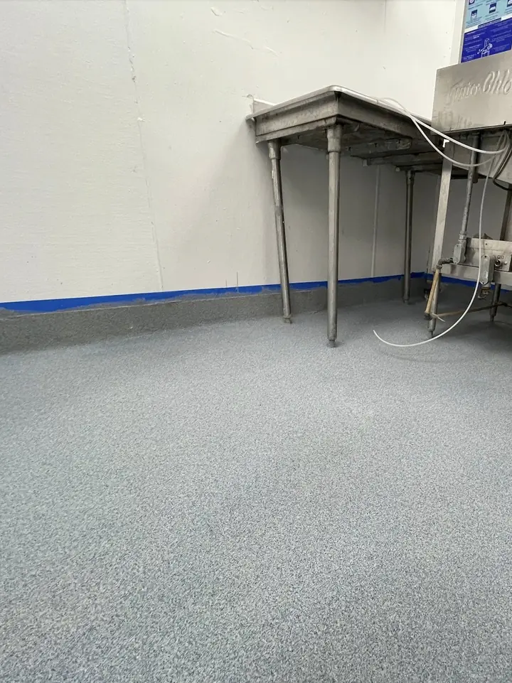 Quartz floor with cove base in a commercial kitchen