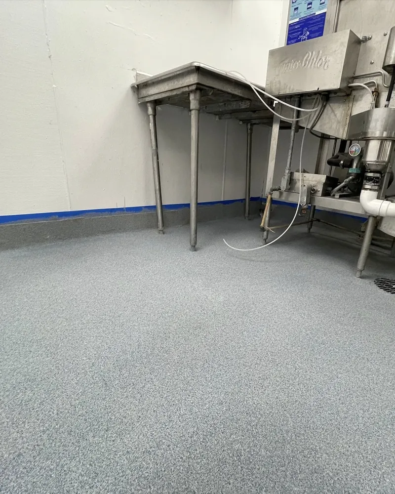 Quartz broadcast floor with cove base in a commercial kitchen